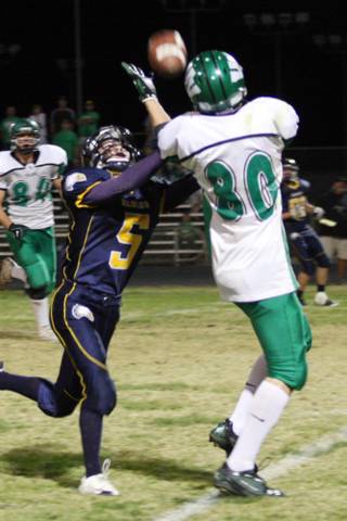 Virgin Valley wide receiver Jonathan Gleave attempts to complete the pass as Joey Felsenfeld of Boulder City tries to steal it during Friday night homecoming football game at Boulder City High School.
