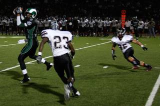 Rancho's Dijon Holman (6) catches the ball before meeting Las Vegas defenders during Friday's Bone Game.