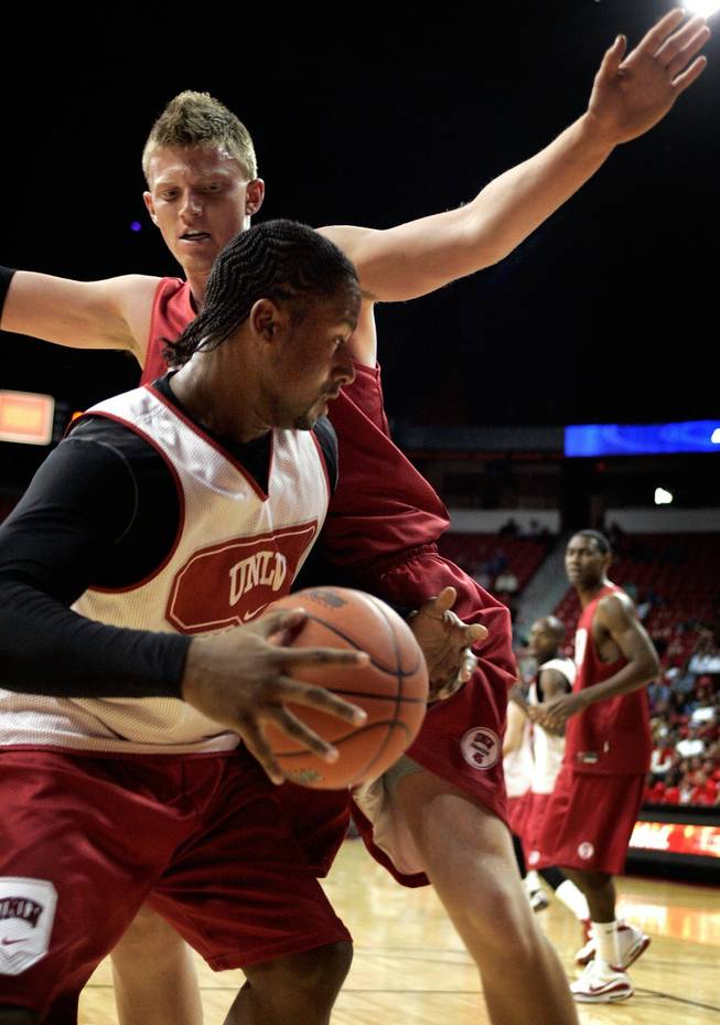Mareceo Rutledge, bottom, tries to rush past teammate Joe Darger during a scrimmage exhibition at the UNLV basketball team's first practice at the Thomas & Mack Center.