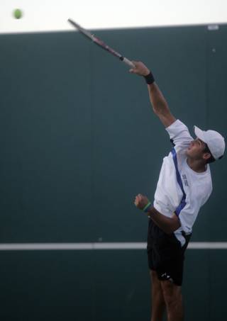 Teaming up with Kyle Del Rosario in a game of doubles, Bishop Gorman's Alec Thomas serves the ball against Bonanza's Aashish Daulat and Andrew Whiting during the Sunset Region tennis finals at the Amanda and Stacy Darling Memorial Tennis Center on Oct. 17. Daulet and Whiting took the win.  

