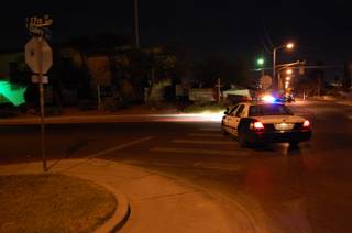A Metro Police car sits at the intersection of 17th and Oakey, where 6-year-old Cole Puffinburger was found just before 11 p.m. Saturday. Cole had been missing since Wednesday morning after he was abducted from his home. 