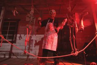 A man portraying a human butcher poses at Bonnie Screams, the haunted ghost town at Bonnie Spring, Oct. 17.
