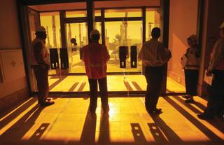 Members of the media look out copper glass doors with custom-cast bronze handles to the pool at Aliante Station Hotel and Casino on Oct. 16.  Due to open on Nov. 11, the $662 million project represents Station Casinos' 18th property in Southern Nevada.  