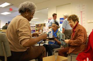 Volunteers put together mailers and literature on Democratic candidates at the Obama-Biden headquarters in Las Vegas Thursday morning. 