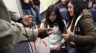 Keynote speaker Khary Black hands out candy to Cristina Escoto, left, and Marvin Rosales, right, during this year's Crossroads program at the Henderson Convention Center on Oct. 22.  