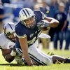 BYU running back Harvey Unga (45) struggles for more yardage against UNLV defensive back Wiselet Rouzard (22) on Oct. 25, 2008.
