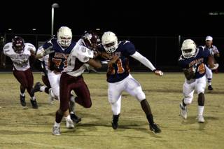 Legacy's Prince Oroke (31) blocks Cimarron-Memorial's Triton Manumaleuna (84) while Martell Crockett (24) carries the ball.
