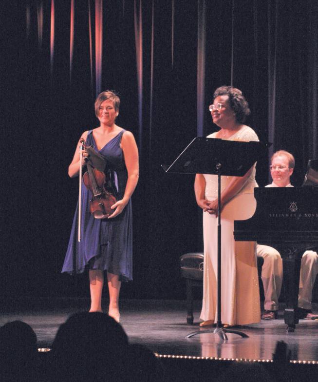 Violinist De Ann Letourneau and pianist Sandra Rivers take a bow while performing for A Grand Evening with Beethoven.