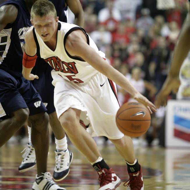 UNLV's Joe Darger dribbles past the Washburn defense.  
