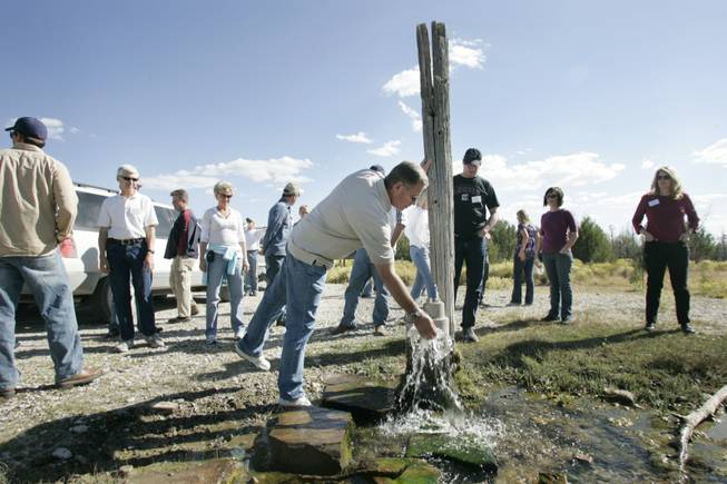 Clark County Commissioner Chip Maxfield feels the water from a well that feeds a stream in Spring Valley inhabited by the Pahrump poolfish during a September tour of northern water resources.