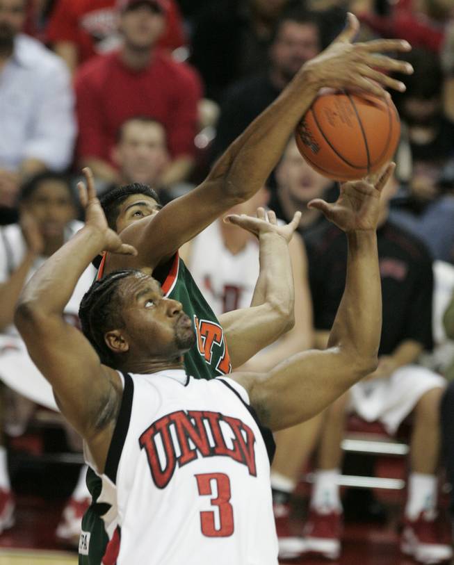 UNLV forward Mareceo Rutledge fights Texas-Pan American forward Luis Valera for a rebound.