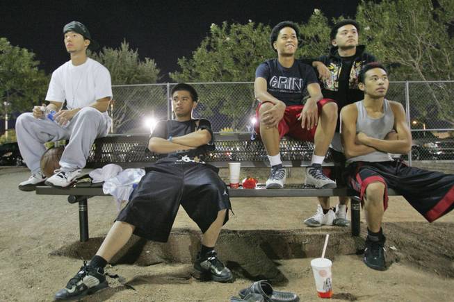 From left, Alan Izawa, Jayson Pascual, Ken Estepa, Justin Delarama and Kalvin Villanueva wait their turn for a court while playing pick-up basketball at the Sunset Park playgrounds.