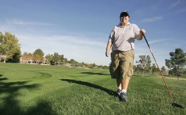 Kari Higa, 33, poses for a portrait at Spanish Trail Golf Course. One of the best amateur golfers in the city, Higa recently won the Spanish Trail Club Championship. 
