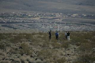 Henderson Police officers investigate the area near where a body was found Friday morning in a desert area near Larson Lane and Rome Street.