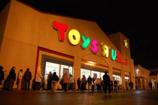 Shoppers wait in line just before midnight Friday before doors open at Toys 