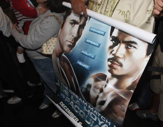 A fan holds a poster as he waits for Oscar De La Hoya to make his official "arrival" at the MGM Grand Tuesday, December 2, 2008.  De La Hoya and Manny Pacquiao will meet in what is being labeled "The Dream Match" at the MGM Grand Garden Arena on Saturday. 