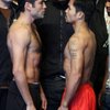 Oscar De La Hoya, left, and Manny Pacquiao face off Friday during the weigh-in at the MGM Grand Garden Arena for their 12-round welterweight fight today. Bernard Hopkins, the former middleweight champion, looks on at center. Oscar De La Hoya, left, and Manny Pacquiao face off Friday during the weigh-in at the MGM Grand Garden Arena for their 12-round welterweight fight today. Bernard Hopkins, the former middleweight champion, looks on at center.