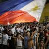 Photo: Filipinos wave a Philippine flag as they celebrate Photo: Filipinos wave a Philippine flag as they celebrate