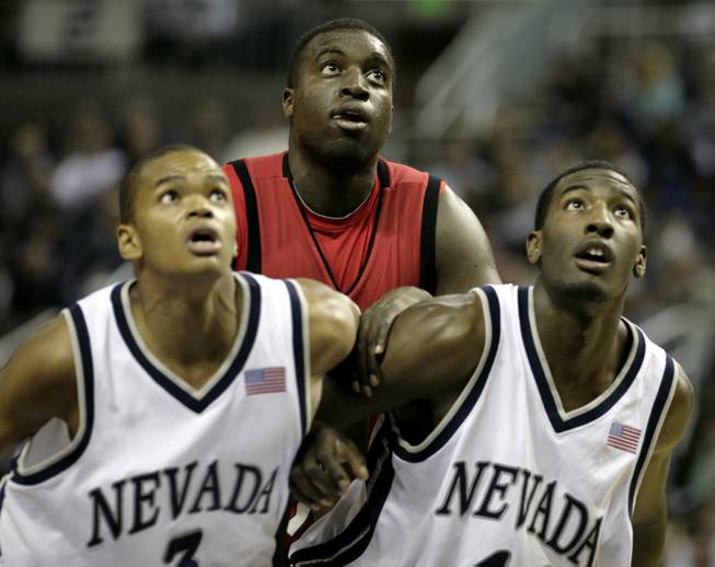 Brice Massamba of UNLV gets boxed out by Joey Shaw (left) and Lyndale Burleson of UNR this season at the Lawlor Events Center in Reno. 
