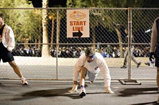 One of more than 15,000 runners stretches on the way to the starting line of the 2008 Las Vegas Marathon on Sunday morning, Dec. 7, 2008.