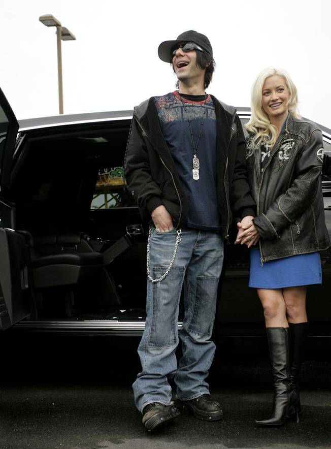 Criss Angel and Holly Madison played Mr. and Mrs. Claus this morning and donated cash and dozens of toys to support Help of Southern Nevada's holiday toy assistance program.