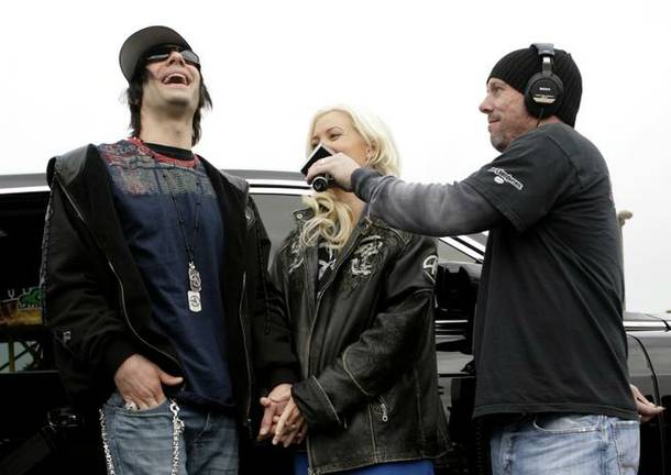 Criss Angel and Holly Madison were interviewed on KLUC 98.5 FM after they donated cash and dozens of toys to the station's annual toy drive.
