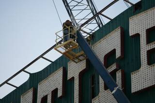 The New Frontier marquee, which stood on the Las Vegas Strip for over six decades, is disassembled by Young Electric Sign Co. (YESCO) employees and Dielco Crane Service, Inc. on Wednesday. 