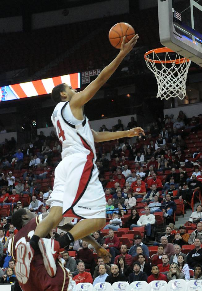 Rene Rougeau lays it in for two last season against Santa Clara. The Rebels will change looks this season, wearing new Nike get-ups which weight 25 percent less than the previous uniforms and have a more retro design to them.