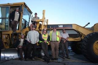 Ed Owens, left on grader, cleared the way to Anthem. Also on the machine is Clint Hall. At bottom, from left, are fellow city workers Darwin Barton, Ryan Minehan, Kurt 