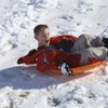 Taking advantage of his school's snow day, Nathan Winder, 8, twirls on his sled down the hills of Anthem Hills Park Thursday morning. Taking advantage of his school's snow day, Nathan Winder, 8, twirls on his sled down the hills of Anthem Hills Park Thursday morning.