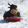 Ten-year-old Blake Forte smiles all the way down the snow-covered hills while sledding at Anthem Hills Park Thursday morning. Ten-year-old Blake Forte smiles all the way down the snow-covered hills while sledding at Anthem Hills Park Thursday morning.