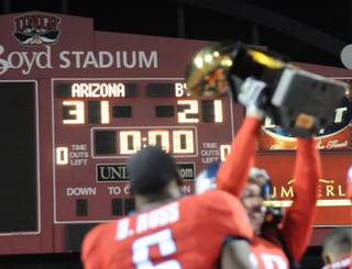 Arizona celebrates a win over BYU during the Pioneer Las Vegas Bowl at Sam Boyd Stadium Saturday. Arizona won the game 31-21.