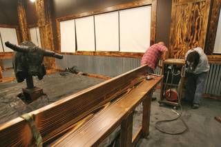 Stoney Gray, owner of the Stoney's Rockin' Country bar on South Las Vegas Boulevard, left, and employee John Good work on the mechanical bull at Stoney's North Forty, scheduled to open on New Year's Eve at Santa Fe Station hotel-casino.