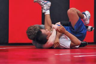 Former Bishop Gorman state champion Napoleon Aniciete trains with Brett Sampson, left, while practicing with the Las Vegas High wrestling team. Per NIAA rules, sophomore Anciete is ineligible to wrestle for one year due to his transfer to East Career and Technical Academy.