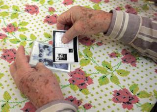 Bernard Judd, a Holocaust survivor, holds a photo of his wife, Eva, and Anne Frank, and a letter between the two as childhood friends. Judd is working with Audrey Levinson, an attorney with ShawJones Partners, to receive reparation payments from the German government.