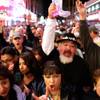 Fans cheer as The Original Kiss Army plays during Tribute Palooza, the 2008 New Year's Eve party at the Fremont Street Experience in downtown Las Vegas.