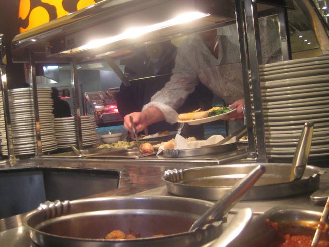 <p>8:05 p.m.: Hungry revelers served (themselves) up plates of prime party-fueling fare and got their fill of New Year's Eve eats at the Palms' Bistro Buffet.</p>
<p>Bellies were being filled with party fuel across the Palms properties -- with pan-Asian specialties from the Little Buddha, contemporary American cuisine from Simon, upscale Italian from Nove Italiano, and Mexican fiesta-fuel from Gardunos, among others - in preparation for the long night ahead.</p>