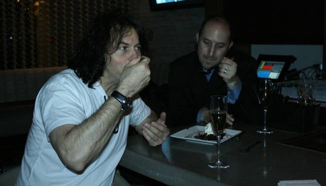<p>1 a.m.: Chef Kerry Simon, left, enjoys a glass of champagne and shares some chocolate-peppermint mousse cake with the director of public relations for Palms Hotel and Casino, Larry Fink, after a hectic New Year's Eve at his namesake restaurant at Palms Place, Simon.</p>
<p>"New Year's Eve is a nutty night," Simon said. "It's pretty crazy."</p>
<p>A slough of stars were spotted wining and dining at the restaurant. Eight-time Olympic gold medalist Michael Phelps, Good Charlotte guitarist Benji Madden, Indy racer Marco Andretti, Brody Jenner of "The Hills," and his girlfriend, 2008 Playmate of the Year, Jayde Nicole, were all on site for the big night.</p>
<p>They enjoyed a range of Simon's signature contemporary American food, including citrus braised</p>
<p>short ribs and charred edamame, and snacked on the chef's signature "junkfood platter" as well.</p>
<p>"We had a very great night; it actually feels like a great night for Las Vegas," Simon said as his night finally came to a close. "People were out and you haven't seen that since before the election."</p>
<p>Though he has another restaurant on the Strip, Simon said the Palms is the place to be on New Year's Eve.</p>
<p>"It was just a great vibe, you've got Michael Phelps running around, you've got Kid Rock playing (at the Pearl)."</p>
<p>He said this year was quite different from last year.</p>
<p>As 2007 came to a close, he was busy with the grand opening of his other restaurant, Cathouse, across town at the Luxor.</p>
<p>Simon said New Year's Eve '08 was quite different compared to last year. He said it lacked the scandal of NYE '07 -- not that that's a bad thing.</p>
<p>He lamented about how a year ago he was caught battling silly rumors that certain celebrities, including a one that Paris Hilton had been banned from his restaurant (not true), and amidst a scandal and resulting fallout from Mischa Barton's DWI (she had agreed to host at Cathouse prior to receiving her DWI but after charges were laid it became somewhat of a PR nightmare.)</p>
<p>He seemed to enjoy welcoming 2009 with a glass of champagne instead of a headache.</p>
<p>The year seemed to be off to a very different start.</p>
<p>"It's just a different vibe," he said as his gaze swept across the sleek and modern surrounds of the restaurant and out through the floor-to-ceiling windows to the turquoise pool outside.</p>
<p>In effort to start the New Year off right, Simon will begin offering a special pajamas party brunch on Sundays from 10 a.m. until 4 p.m.</p>
<p>The chef, meanwhile, also hopes to make a few changes in the new year. His resolution, he said, will be "to be as healthy as possible and get some free time ... because I really haven't for a long time."</p>