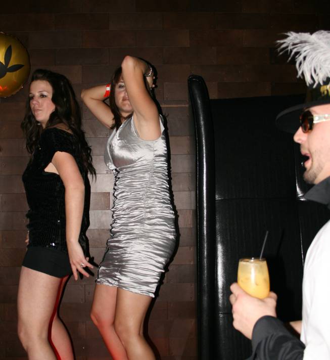 <p>2:50 a.m.: Two Playboy Club patrons show that the bar's famed bunnies aren't the only ones lacking inhibition as they shake it for the onlooking crowd.</p>
<p>The bunny suited staff at Playboy Club always give partiers plenty to look at and of course New Year's Eve was no different. Stunning and svelte servers and dealers were at their bunny best, donning the ceremonial ears and cuffs but not a whole lot else.</p>