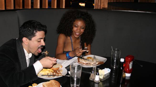 <p>4:30 a.m.: Will Rodriguez, left, and Christina Rowe, right, met on the Palms casino floor and got to know each other over an early New Year's Eve breakfast at the casino's 24/7 Cafe.</p>
<p>"My friends went to bed and want to sleep in," Rowe explained.</p>
<p>The pair met while playing the slots but later took their chances on roulette before cashing in for the night.</p>
<p>"I saw her at the slot machines and I told her, 'I'm going to play roulette'," Rodriguez said.</p>
<p>"I said bet fours and fives," Rowe said. "He didn't listen to me -- but he should have."</p>
<p>"I bet on sevens, I think, and I lost," Rodriguez said.</p>
<p>But all was not lost at the roulette tables, as Rodriguez won himself a casual breakfast date.</p>
<p>Rowe ordered the country fried steak and eggs while Rodriguez opted for the three egg breakfast, scrambled, with hashbrowns.</p>
<p>The new pair agreed said breakfast was just what the doctor ordered after a long night of partying at the Palms.</p>
<p>Rowe spent the night at Moon while Rodriguez rang in 2009 at Rain.</p>
<p>"It absorbs all the alcohol," Rowe said with a laugh. "And it's already late so it's close to the morning time."</p>
<p>As it tuned out, she and Rodriguez were lucky to enjoy their eggs when they did: When the rest of the hotel's guests awoke to the first morning of the year a few short hours later, crowds of hungry partiers converged upon the popular breakfast spot.</p>
<p>And while grumbling stomachs were forced to wait in line, Rowe and Rodriguez didn't have to worry since breakfast was already taken care of.</p>