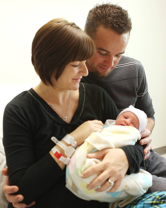 Father Chris, right, and mother Tristin Arnold hold 5-pound 7-ounce Harper Arnold, born at 12:53 a.m. Jan. 1 at Centennial Hills Hospital.
