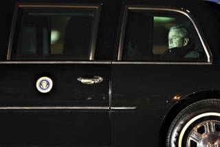 LONELY JOB | JAN. 30
President Bush arrives at McCarran International Airport before delivering a speech on the war on terrorism at the Nevada Policy Research Institute. I waited with other local media on the tarmac for hours in the cold as it seemed that Air Force One might never arrive. When the president's plane finally landed, the motorcade blocked most of my views of his exit from the plane. I watched through my 400 mm telephoto lens for any glimpse. Then, I got a clear view as the presidential limo pulled away. President Bush sat alone, appearing worn. When I look at this frame now, I feel it holds the essence of his quickly approaching exit from office.

