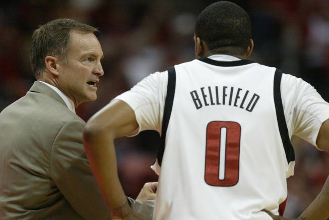 UNLV head coach Lon Kruger speaks with guard Oscar Bellfield during a break in the first half of their game against New Mexico at the Thomas & Mack Center.