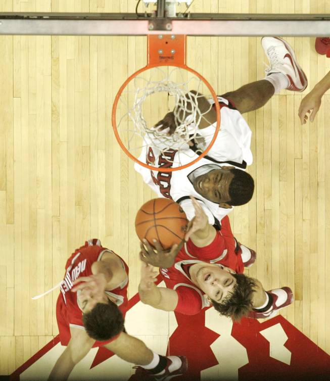 UNLV forward Darris Santee grabs a rebound away from New Mexico forward Daniel Faris during the second half of their Mountain West Conference opener at the Thomas & Mack Center.