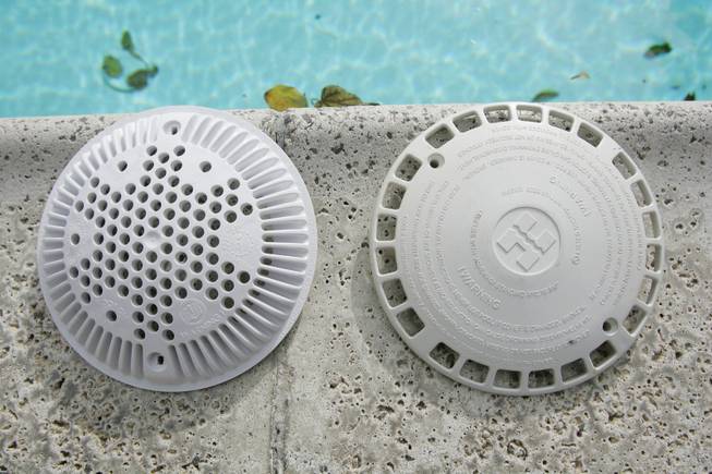 An old pool drain cover, right, is seen next to a new anti-entrapment pool drain covers designed to prevent death. The law requires that all pools and spas to have drain covers installed and a second anti-entrapment system added when there is only a single main drain.