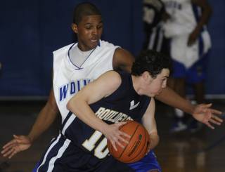 Basic junior John Polin (5) defends against Boulder City's Joey Felsenfeld (10) during the first half of a game at Basic High on Monday night.