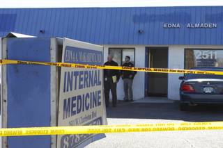 Crime scene tape hangs around the office of Dr. Edna Makabenta after an apparent murder-suicide on Monday. Metropolitan police officers guard the door to her West Charleston practice. Makabenta was killed by a patient who then turned the gun on himself, police said.