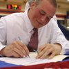 Bishop Gorman defensive end Justin Chaisson signs his letter of intent to play college football for Oklahoma at Bishop Gorman High School on Wednesday.
