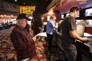 Steven Stephenson of Las Vegas waits to make a bet on the Super Bowl at the Las Vegas Hilton sports book Thursday, February 4, 2010. The Hilton was one of the only sports books in Las Vegas to report a losing Super Bowl. 