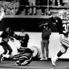 Former UNLV football great Elbert "Ickey" Woods celebrates as he breaks away from defenders and heads for the endzone. 